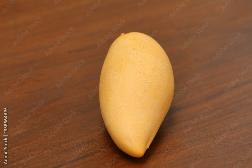 Mangifera indica L.Mango on the wood flooring Mangifera indica L.Mango on the wood flooring