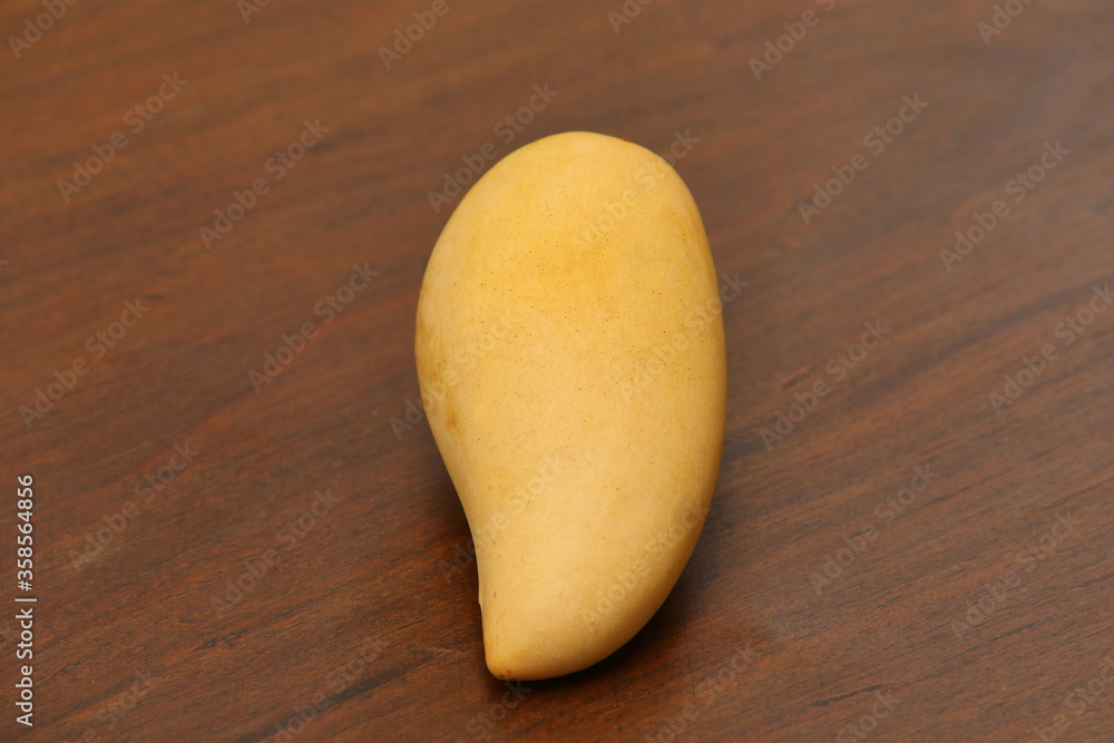 Mangifera indica L.Mango on the wood flooring Mangifera indica L.Mango on the wood flooring