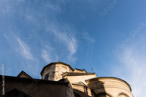 low angle view of ancient church against blue sky in lviv, ukraine