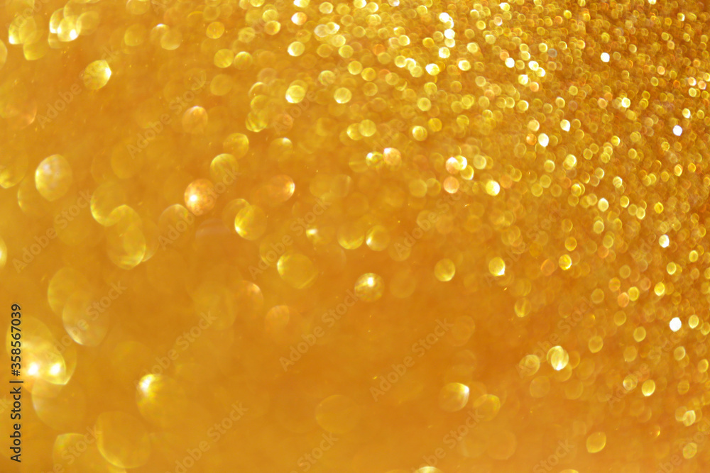 Golden sparkle glitters with bokeh effect and selectieve focus. Festive background with bright gold lights, champagne bubble. Christmas mood concept. Copy space, close up, texture, top view. Golden sparkle glitters with bokeh effect and selectieve focus. Festive background with bright gold lights, champagne bubble. Christmas mood concept. Copy space, close up, texture, top view.