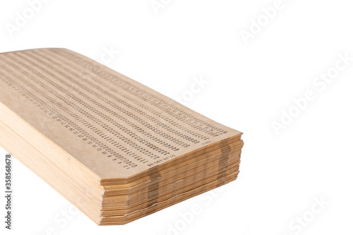 A pack of paper punch cards for storing information in the first electronic computers isolated on a white background. Data storage.