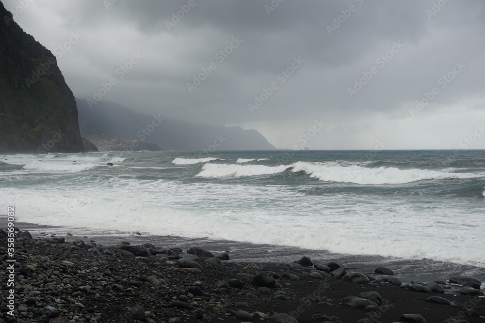 Madeira cliffs and islands in cloudy day, rough ocean