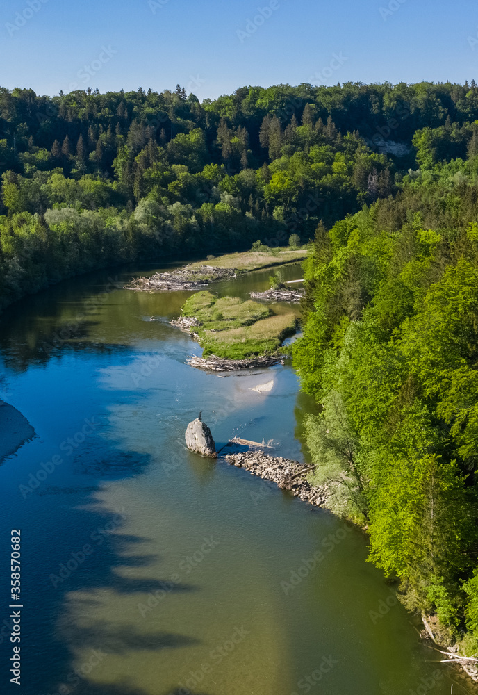Bird view of nice corner in the Isar river in Munich with forest nearby drone image