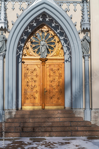 wooden church door with beautiful wood carvings in a suburban park near St. Petersburg, Russia