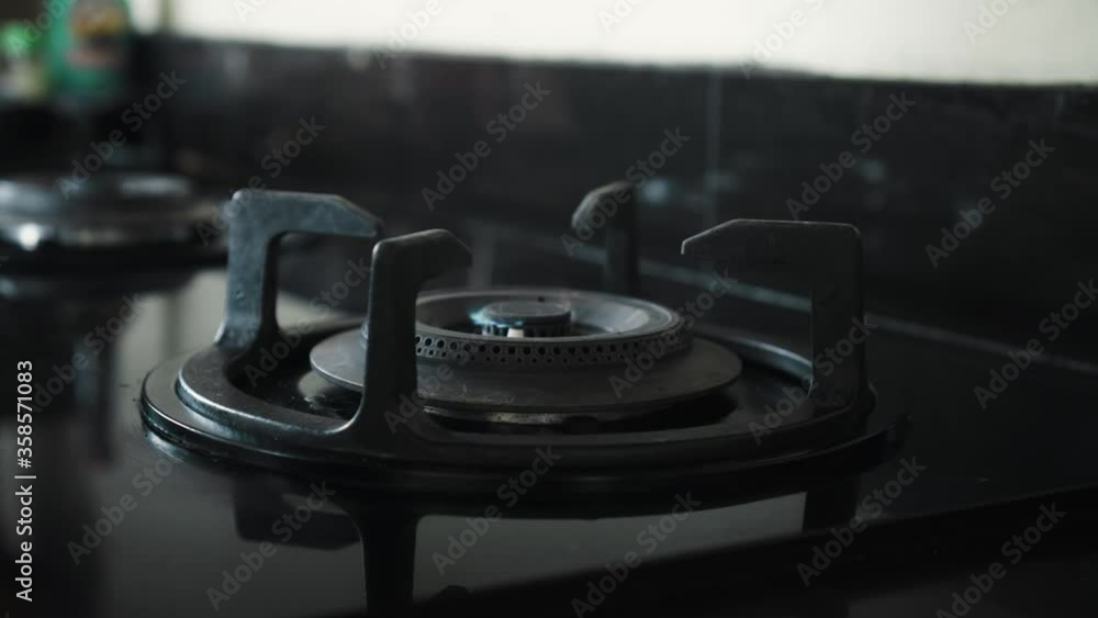 video of a black gas stove with blue and red burning flame in the kitchen video of a black gas stove with blue and red burning flame in the kitchen