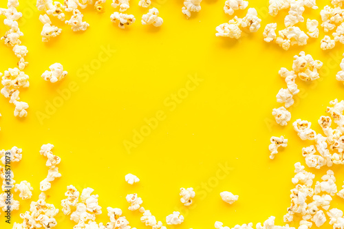Popcorn mockup on yellow background top view copy space