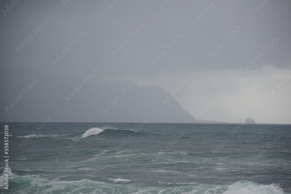 Madeira cliffs and islands in cloudy day, rough ocean
