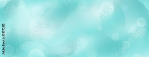 Abstract background with bokeh effects in light blue colors