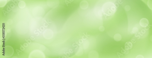 Abstract background with bokeh effects in green colors