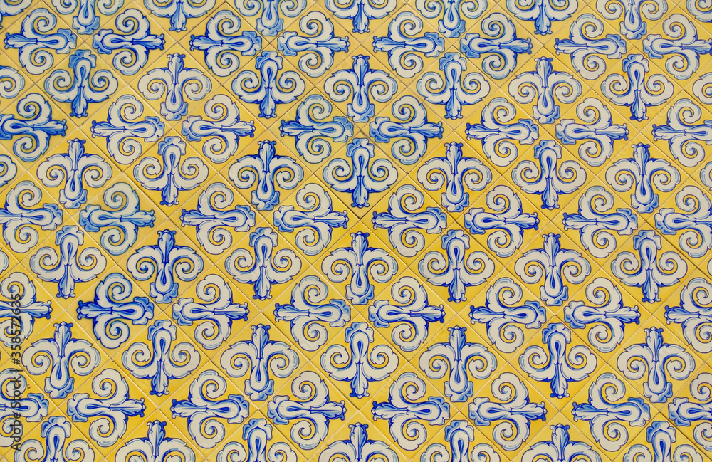 Patterned tiles wall of vibrant yellow and blue colours outside in Valencia, Spain
