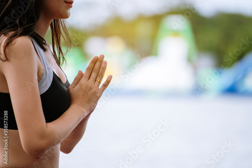 Yoga fitness lifestyle healthy woman relaxation doing a meditation. Yoga meditating outdoor with zen on sitting position. Young exercise concept.