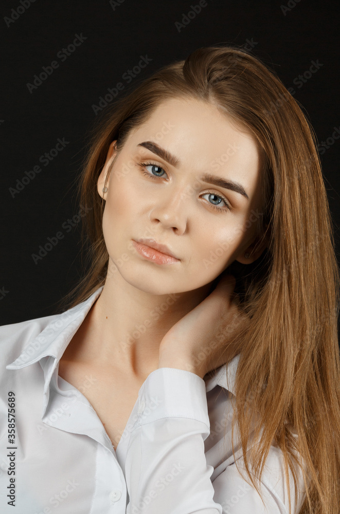 Beauty woman with healthy skin and hairstyle, red-haired young girl with long hair on a dark background Female portrait. Vertical view Beauty woman with healthy skin and hairstyle, red-haired young girl with long hair on a dark background Female portrait. Vertical view