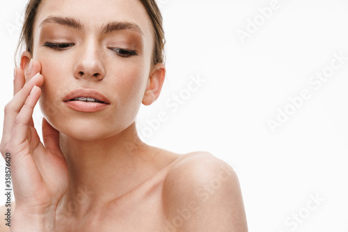 Image of beautiful caucasian young shirtless woman standing isolated