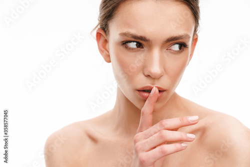 Image of beautiful brunette shirtless woman showing silence gesture