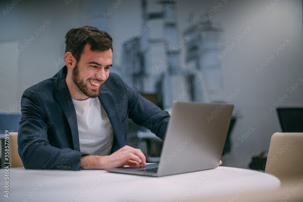 Portrait of contemporary young businessman at a working laptop. Portrait of contemporary young businessman at a working laptop.