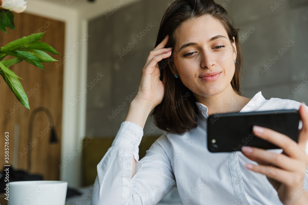 Attractive smiling young lovely brunette woman watching video Attractive smiling young lovely brunette woman watching video
