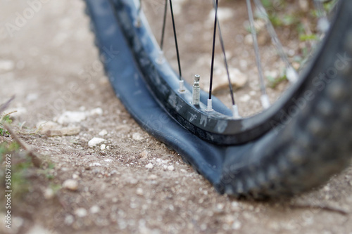 Mountain bike got Flat bike tire on trail. Selective focus..