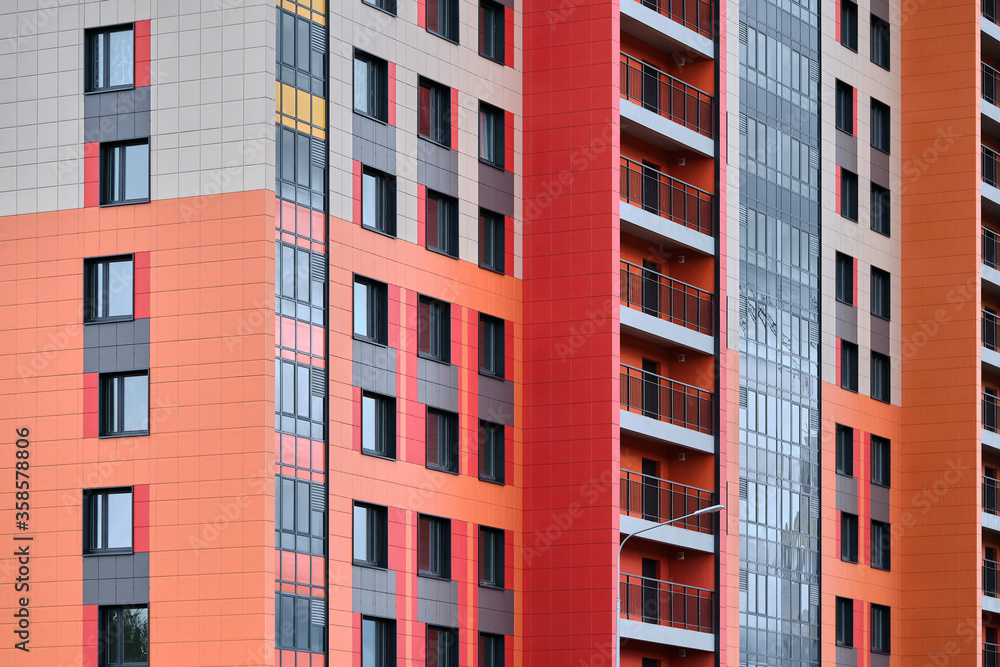 built colorful house with panoramic balconies near the construction site in the new residential district. concrete building technology 