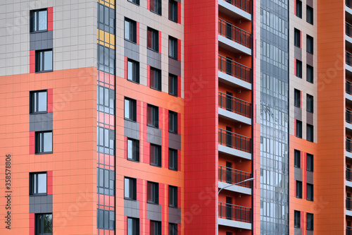 built colorful house with panoramic balconies near the construction site in the new residential district. concrete building technology 