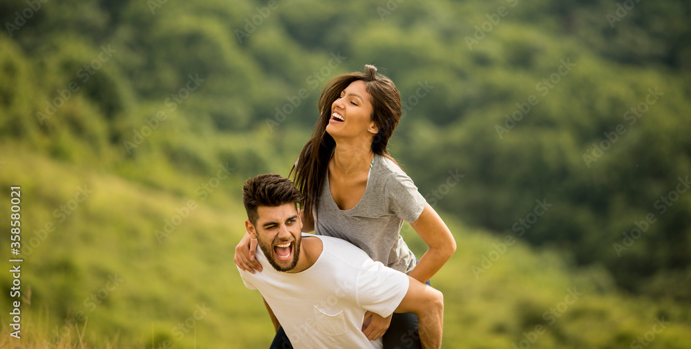 Pretty young couple in love outside in spring nature Pretty young couple in love outside in spring nature
