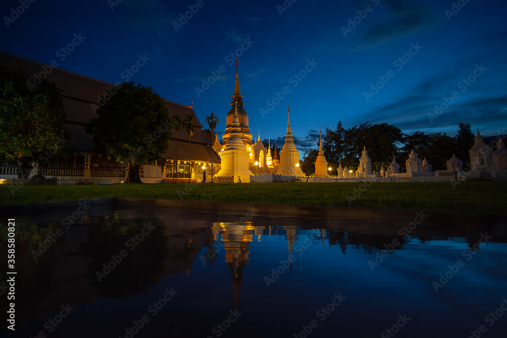 Wat Suan Dok Temple in twilight and reflection in Chiang Mai Thailand. Landmark of Chiang Mai.