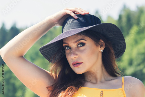 beautiful young woman with a hat Portrait close up in nature