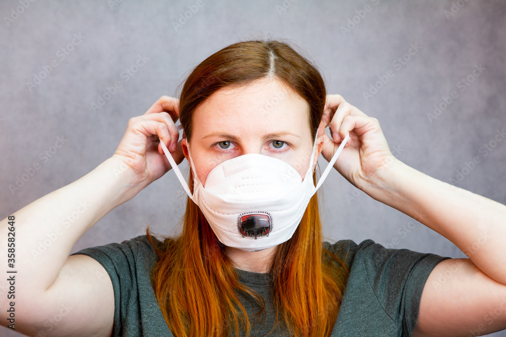 Beautiful woman wearing respiratory mask for the new rapidly spreading Coronavirus, COVID-19 Beautiful woman wearing respiratory mask for the new rapidly spreading Coronavirus, COVID-19