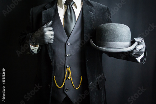 Foto Portrait of British Businessman in Leather Gloves Holding Bowler Hat