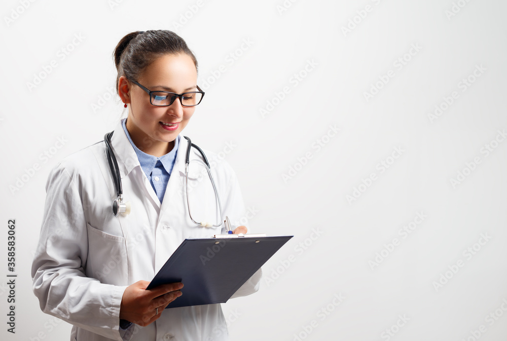 Smiling female doctor holding a clipboard on a white background. Smiling female doctor holding a clipboard on a white background.