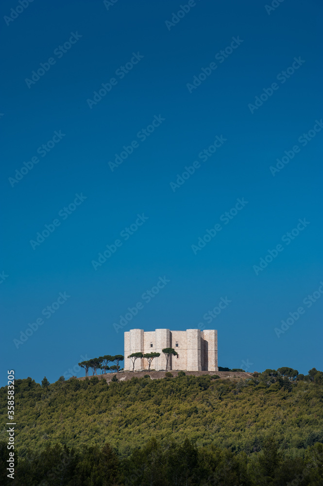 Castel del Monte in the countryside of Andra Apulia region standing out against the blue sky