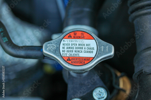 Vehicle radiator cap with warning label