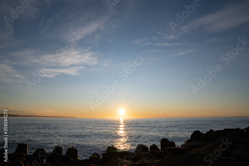 Beautiful view to rocky waterbreak in Oamaru, New Zealand with golden sunset.