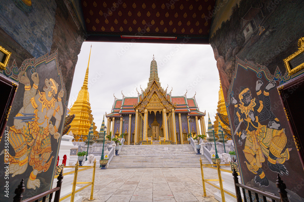 Fototapeta premium Wat Phra Kaew, wat Phra Si Rattana Satsadaram or Temple of the Emerald Buddha temple entrance that has beautiful to golden Hor Phra Rajkoramanusorn landmark in BANGKOK/THAILAND