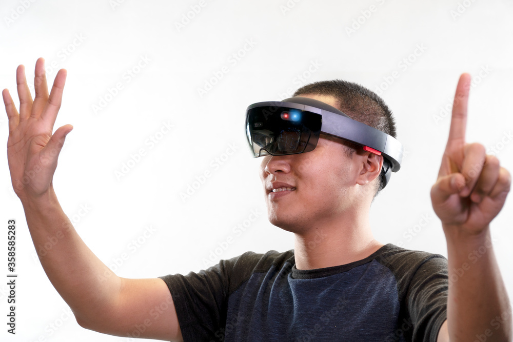 Young man with eye wear glasses hololens gesture action on white background. Mixed reality in future advanced technology concept. Young man with eye wear glasses hololens gesture action on white background. Mixed reality in future advanced technology concept.