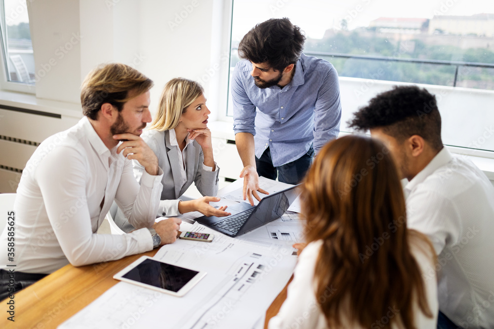 Group of business people meeting in office, sharing their ideas. Group of business people meeting in office, sharing their ideas.