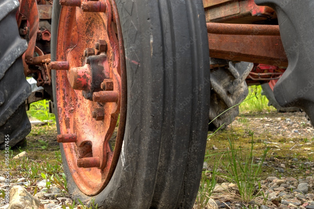 old red rusted tractor wheel