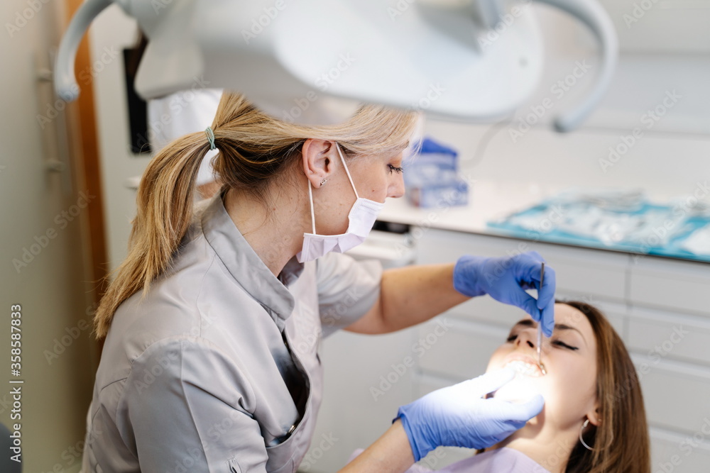 Dentist examining teeth of woman Dentist examining teeth of woman