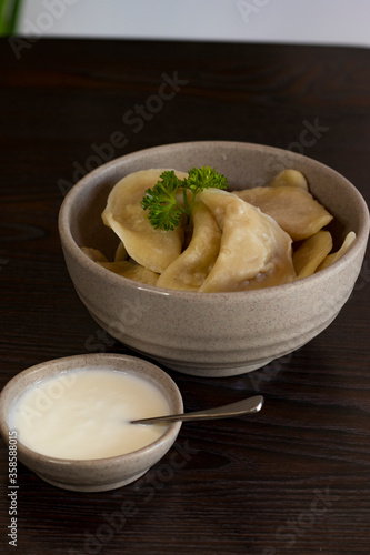 Homemade dumplings, Russian dumplings. dumplings, ravioli. on a wooden table