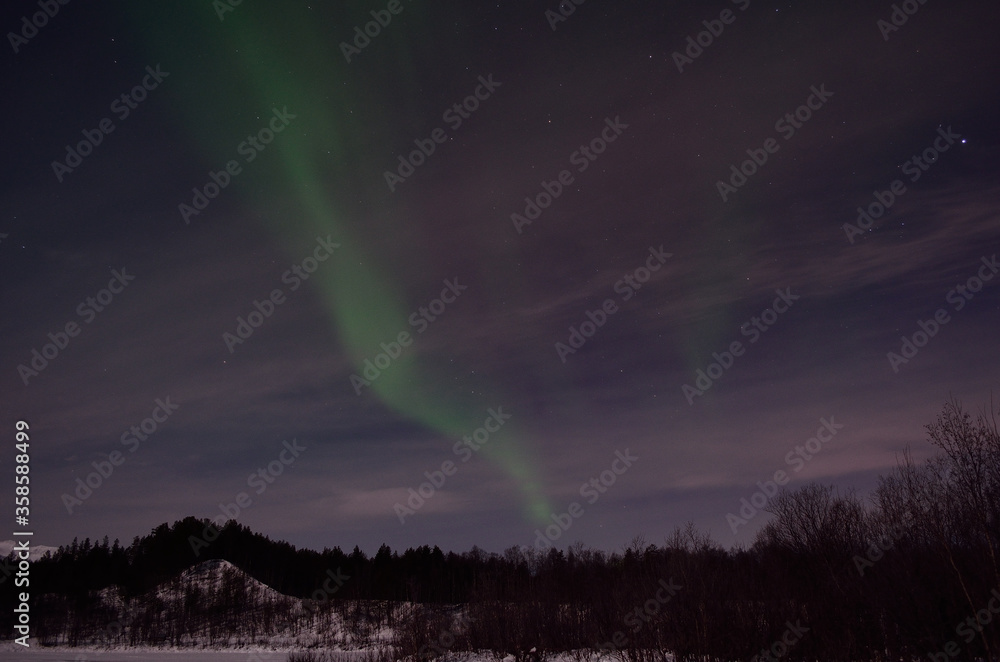 aurora borealis, northern light over winter river landscape at night with full moon lighting