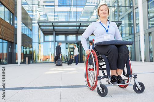 Businesswoman as a wheelchair user in front of the office