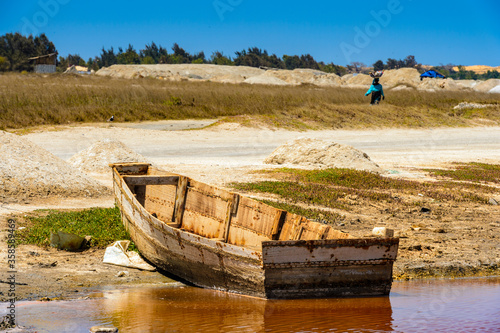 It's Abandoned boat on the shore of the pink lake called Lake Retba or Lac Rose, Senegal photo