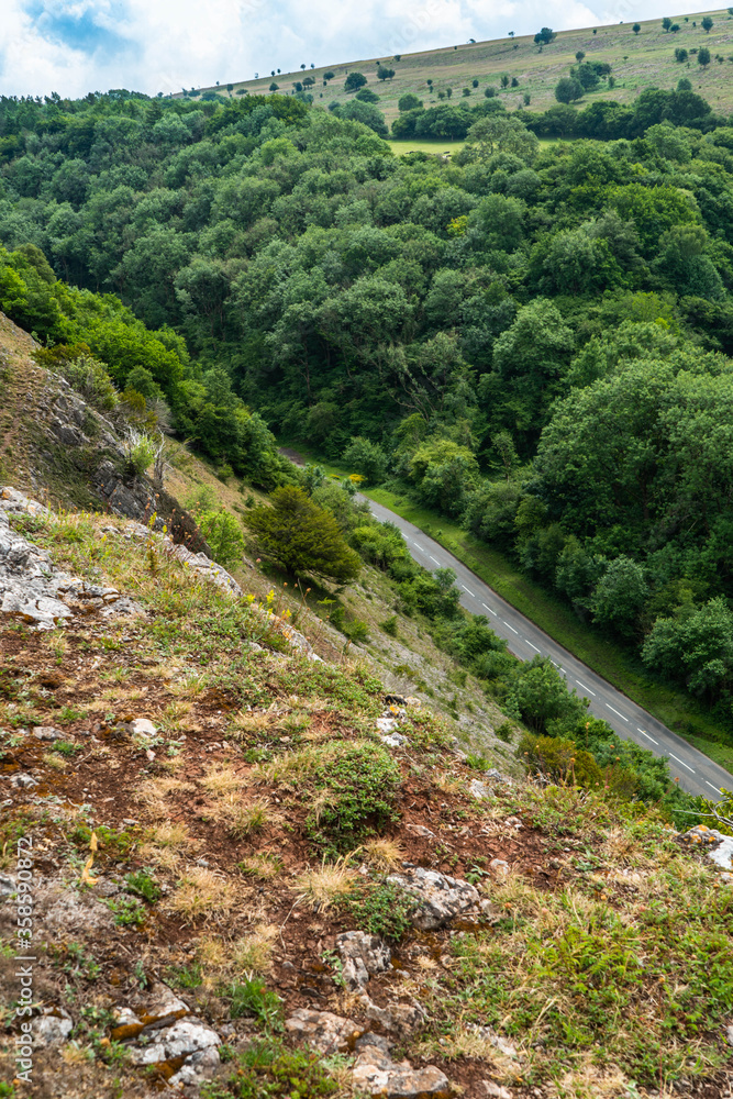 View down to section of Cliff Road which winds through the cheddar gorge rock faces and steep cliffs near Bristol in North Somerset