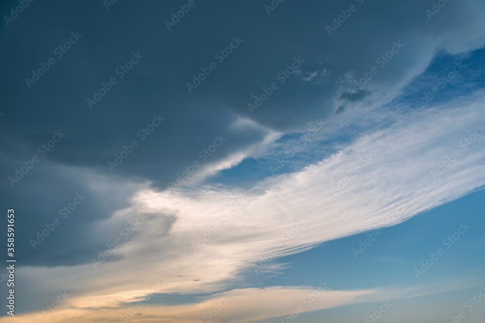 Fototapeta premium Dark storm clouds before rain at sunset.