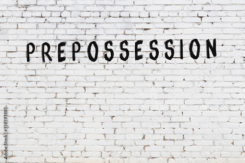 Word prepossession painted on white brick wall photo