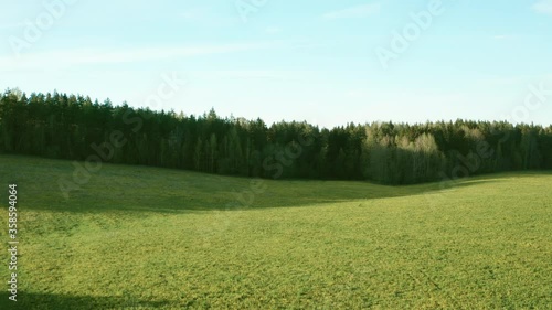 The drone’s camera takes off from a field sown with dandelions, revealing a view of the vast expanses of fields and forests
