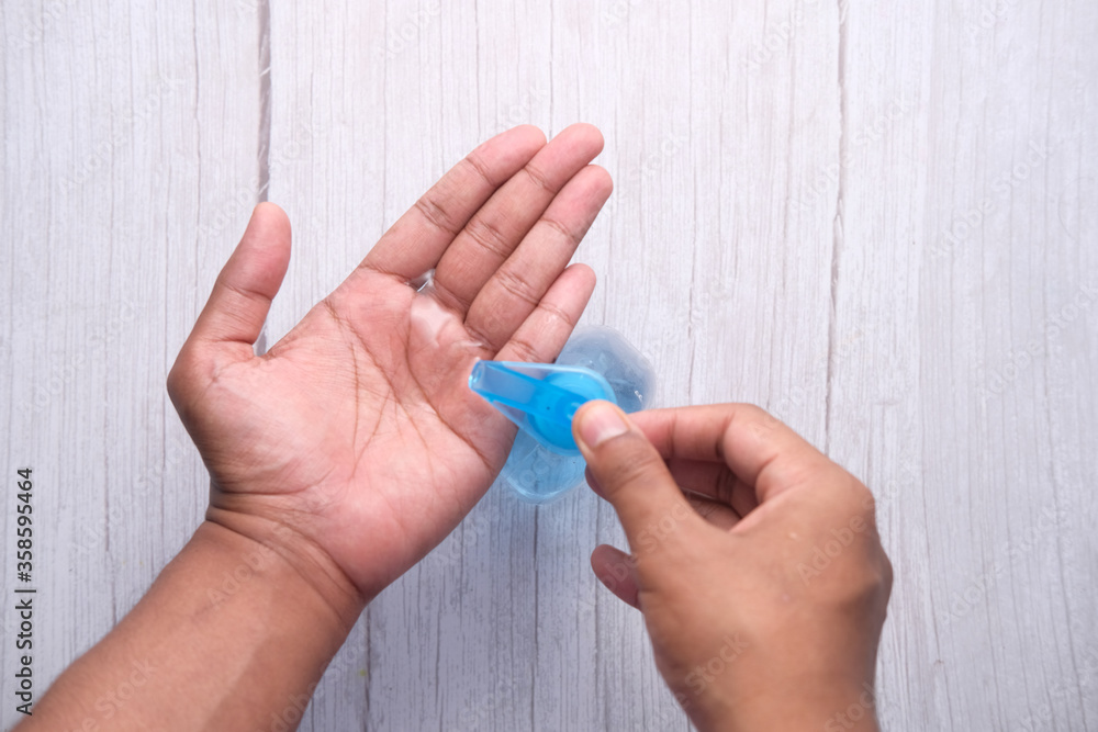 man's hands using hand sanitizer gel, close up man's hands using hand sanitizer gel, close up