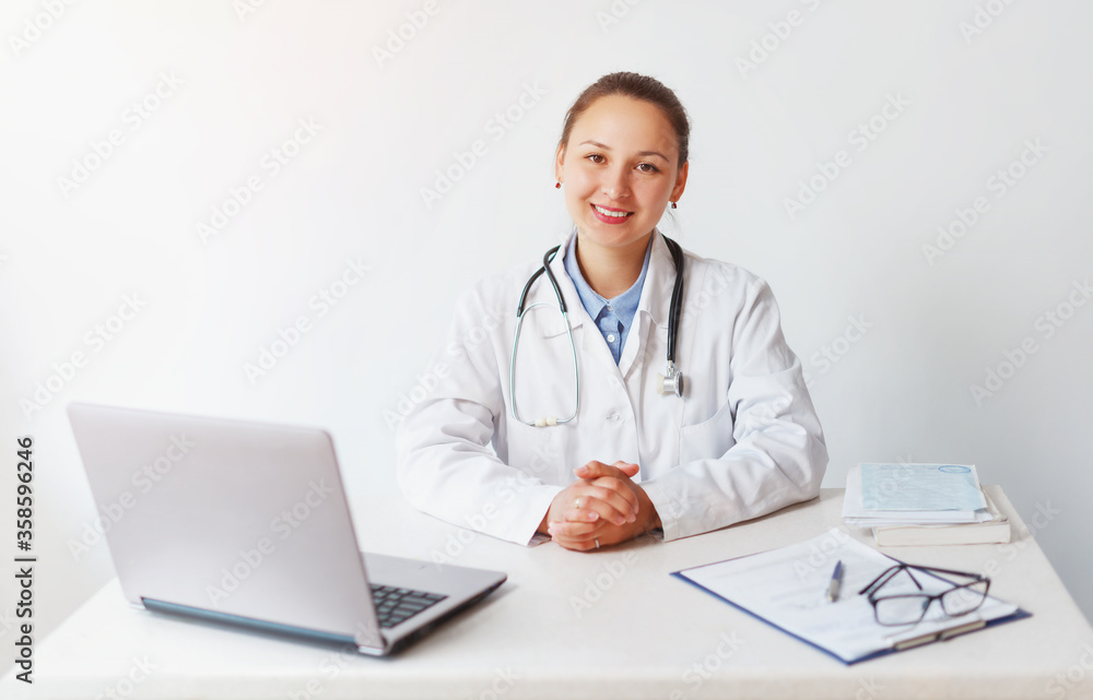 portrait of a smiling female doctor at her workplace portrait of a smiling female doctor at her workplace