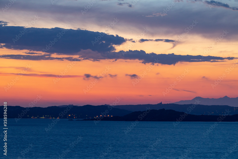 Colourful Blue Hour Sunset: Mediterranean Seascape: Islands of La Maddalena and Caprera With Vivid Sky and Distant Mountains of Corsica, From Northern Sardinia. Colourful Blue Hour Sunset: Mediterranean Seascape: Islands of La Maddalena and Caprera With Vivid Sky and Distant Mountains of Corsica, From Northern Sardinia.