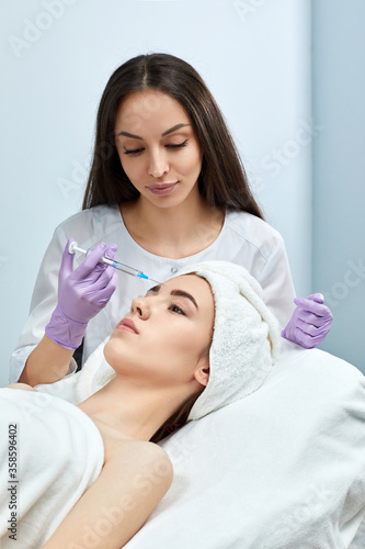 beautiful woman getting facial beauty injections in beauty salon. Cosmetology concept.