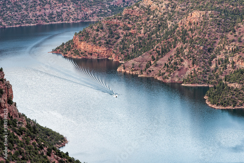 Canyon Rim trail overlook view near campground in Flaming Gorge Utah National Park with Green River at sunset with boat photo